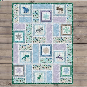 May include: A patchwork quilt with a Scandinavian winter theme. The quilt features squares with images of a bear, moose, deer, and snowflakes in shades of blue, purple, and green. The text "Scandi Building Block Blanket" is visible.