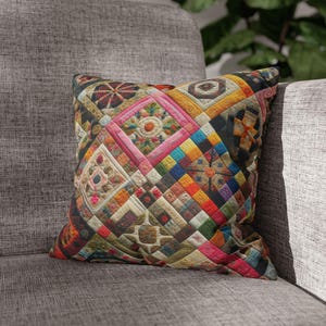 May include: A square throw cushion featuring a vibrant patchwork design composed of numerous small, multi-coloured fabric squares and geometric shapes in shades of pink, yellow, blue, orange, and green, arranged in a complex, repeating quilt-like pattern.