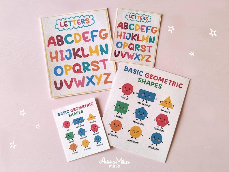 Miniature educational flashcards featuring colorful alphabet letters and basic geometric shapes with cute faces, designed for dollhouse classrooms, school crafts, or early learning play, displayed on a light pink background. By Aninka Miller Minis