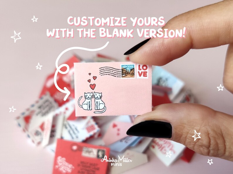 A hand holds a customizable blank miniature Valentine's Day envelope by Aninka Miller Minis, featuring two cute illustrated cats and red hearts. Text reads "Customize yours with the blank version!". Ideal DIY printables for dollhouses in 1:6 and 1:12 scales, perfect for creating personalized romantic doll stationery and love letters.