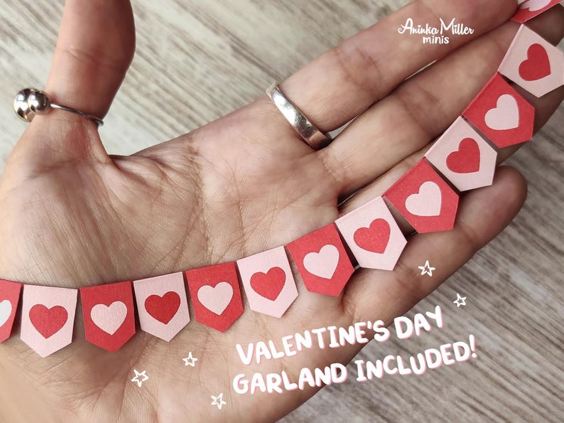 Miniature Valentines Day garland, handmade heart banner in red and pink, perfect for dollhouses, holiday decorations and crafts. Includes tiny heart-shaped flags for a festive, charming Valentine's Day look. Ideal for 1:12 or 1:6 scale dioramas