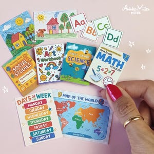 May include: A selection of miniature educational resources, including activity books for social studies and art, a science book, a maths workbook, flashcards, a days of the week chart, and a world map. The items are brightly coloured and designed for children.