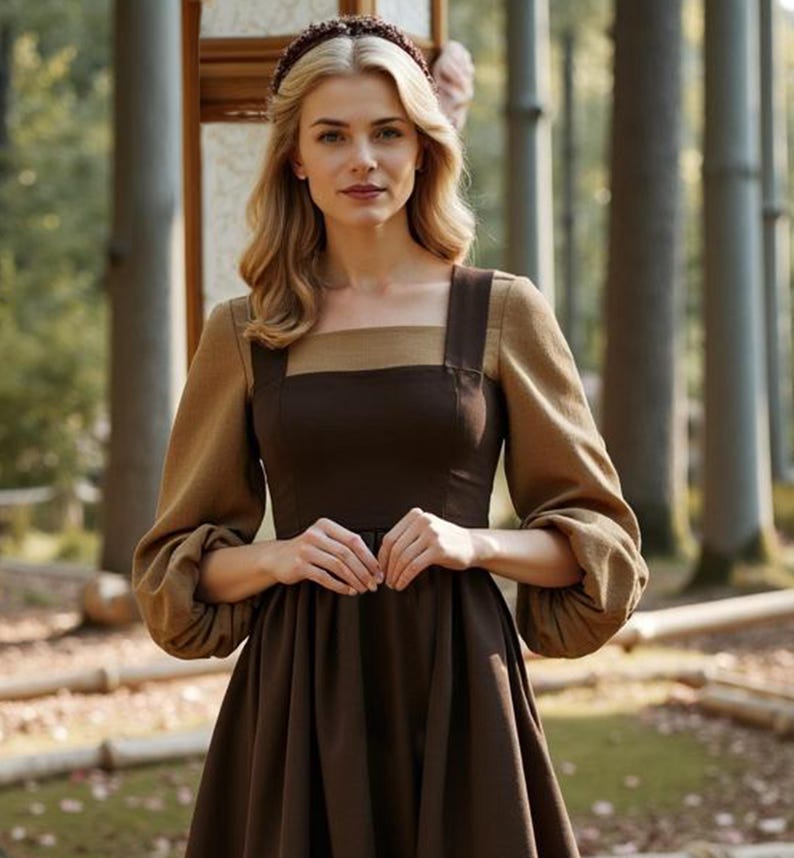 May include: A woman wearing a brown dress with a square neckline and long sleeves. The dress has a brown and tan bodice and a brown skirt. The woman is wearing a brown headband and has long blonde hair.