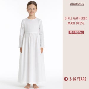 May include: A girl wears a white, long-sleeved maxi dress. The dress has a gathered waist and a flowing skirt. Text on the right side reads "GIRLS GATHERED MAXI DRESS" and "PDF DIGITAL". The age range is indicated as 2-16 years.