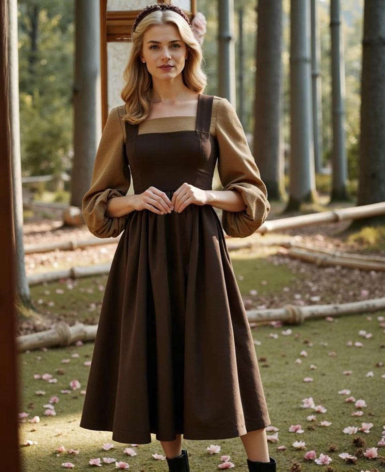 May include: A brown midi dress with a square neckline and a brown and tan color block design. The dress has long sleeves with puffed cuffs and a gathered skirt.