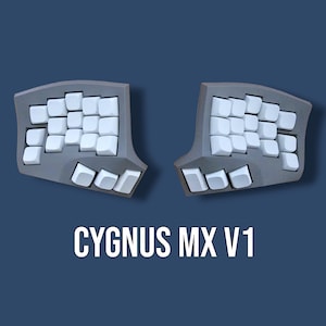 May include: A split ergonomic keyboard with two dark gray contoured halves featuring white blank keycaps. The device is labeled with the text CYGNUS MX V1 centered below the two keyboard sections, which are arranged in a symmetrical layout.