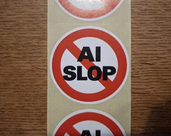 May include: A circular sticker featuring a red prohibition symbol with a diagonal line across a white background. The text AI SLOP is printed in bold black capital letters in the center of the circle. The sticker is part of a vertical strip.