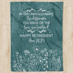 May include: Teal blanket with white floral design and text: "NEVER UNDERESTIMATE the difference YOU MADE OR THE lives you touched HAPPY RETIREMENT Ana 2025". A retirement gift.