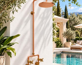 May include: A wall-mounted outdoor shower system constructed from copper piping, featuring a circular shower head, a vertical pipe, and two brass cross-handle valves at the base. The fixture is mounted to a white wall with circular plates.