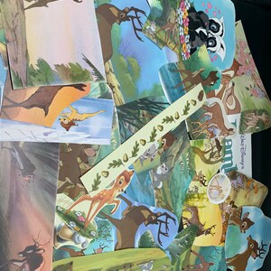 May include: A collection of colorful, illustrated cards featuring Bambi, the Disney character, in various scenes from the movie. The cards are cut out and arranged in a random pattern, creating a whimsical collage.