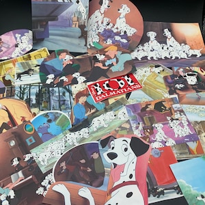 May include: A collection of 101 Dalmatians themed paper cutouts featuring various scenes from the movie. The cutouts include images of Dalmatian puppies, the villain Cruella De Vil, and the iconic "101 Dalmatians" logo.
