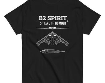 May include: Black t-shirt featuring a white graphic of a B2 Spirit stealth bomber. The text "B2 SPIRIT STEALTH BOMBER" is printed above the aircraft illustration. The shirt is made of a soft, comfortable material.