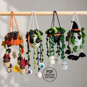 May include: Four hanging crochet plant decorations featuring Halloween themes: an orange pumpkin with acorns and leaves, a white skull with eyeballs, a black witch hat with green vines and ghosts, and a white ghost wearing a witch hat with black bats.
