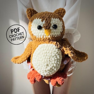 May include: A handmade crochet owl in shades of brown, cream, and orange. The owl has large black eyes, a yellow beak, and a cream-colored belly. The image includes the text "PDF CROCHET PATTERN" in a circular design.