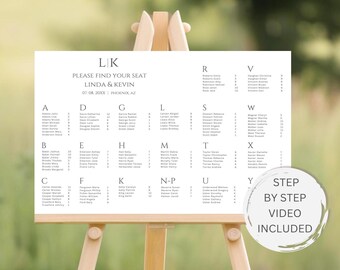 May include: A white wedding seating chart with the names of guests listed alphabetically by last name. The chart is on a wooden easel and has the text "LK PLEASE FIND YOUR SEAT LINDA & KEVIN 07.08.20XX PHOENIX, AZ" at the top. A white circle with the text "STEP BY STEP VIDEO INCLUDED" is in the lower right corner.