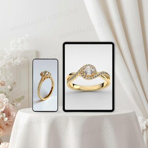 Op de afbeelding: Een gouden verlovingsring met een grote, ronde, heldere middensteen en kleinere stenen in de band. De ring wordt getoond op een tablet en een smartphone. De ring staat op een wit oppervlak.