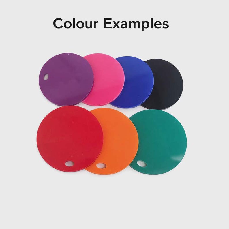 May include: A collection of eight circular objects in various colors, including purple, pink, blue, black, red, orange, and green. Each disc has a small hole near the edge. The text "Colour Examples" is at the top.