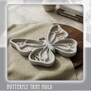 May include: A gray butterfly-shaped jewelry tray filled with rings, earrings, and a bracelet. The tray is made of a smooth material and has multiple compartments. The text "BUTTERFLY TRAY MOLD" and "Digital Files Only" are visible.