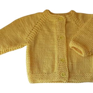 May include: A yellow knitted baby cardigan with long sleeves and three matching buttons. The handmade sweater has a round neckline and ribbed cuffs and hem. The soft, warm garment is perfect for a baby.