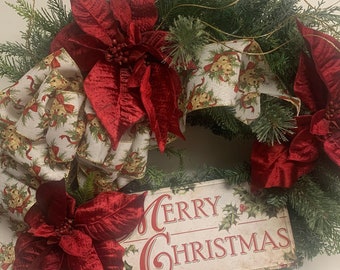 24" artificial pine wreath, red poinsettias, fern greenery, metal Merry Christmas sign