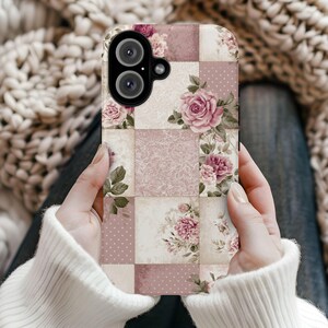 May include: A phone case featuring a patchwork design with floral patterns in shades of pink, cream, and mauve. The case has a camera cutout and a glossy finish, with a vintage aesthetic.