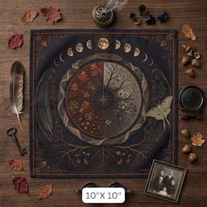 May include: A square black fabric altar cloth measuring 10 inches by 10 inches, featuring a central circular design divided into four seasonal quadrants, surrounded by a snake, moon phases, a moth, and tree roots in shades of brown and gold.