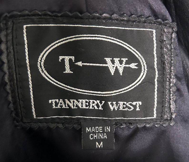 May include: Black leather jacket with a black label that says "T-W Tannery West" and "Made in China" with a size "M" tag.