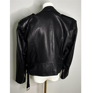 May include: A black leather motorcycle jacket with a zipper closure and a stand-up collar.
