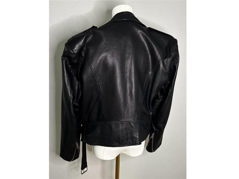 May include: A black leather motorcycle jacket with a zipper closure and a stand-up collar.