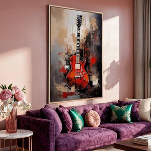 a painting of a guitar on a wall above a bed
