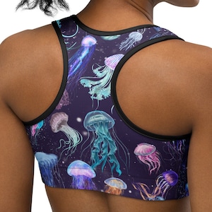 May include: A black sports bra with a colorful jellyfish print. The bra has a racerback style and is made of a stretchy, breathable fabric.