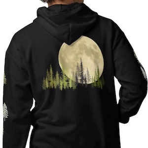 May include: Black hooded sweatshirt with a full moon and forest silhouette graphic on the back.
