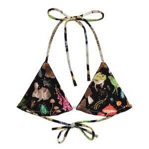 May include: A black triangle bikini top with a colorful print of insects, mushrooms, and a frog. The top has adjustable straps and a tie closure at the back.