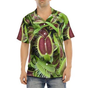May include: A short-sleeved button-up shirt with a green, red, and white print of Venus flytraps.