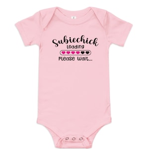 May include: Pink baby onesie with black text that reads "Subiechick Loading Please Wait..." with a pink and black progress bar.