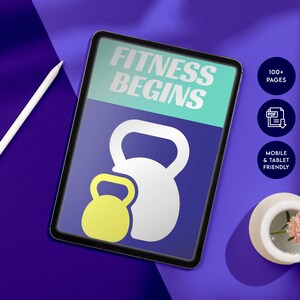 May include: A digital tablet displaying a fitness guide with the text "Fitness Begins" and an illustration of two kettlebells. The tablet is on a purple surface with a white pencil and a small white pot with a pink flower.
