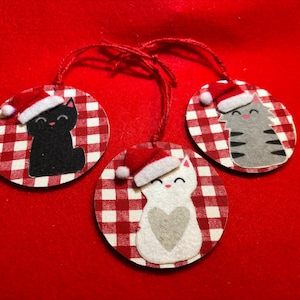 Adorable Christmas ornaments with flannel kittens in felt Santa hats. Sweet gray tabby, black cat, and white cat with gray heart.  Cat lover