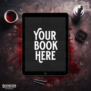 May include: A black tablet computer with a white background and the text "YOUR BOOK HERE" displayed on the screen. The tablet is surrounded by red blood splatters on a dark gray surface.