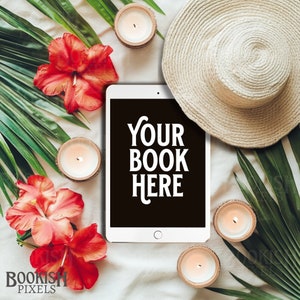 May include: A white tablet with a black screen displaying the text "YOUR BOOK HERE" surrounded by tropical leaves, candles, and a straw hat.