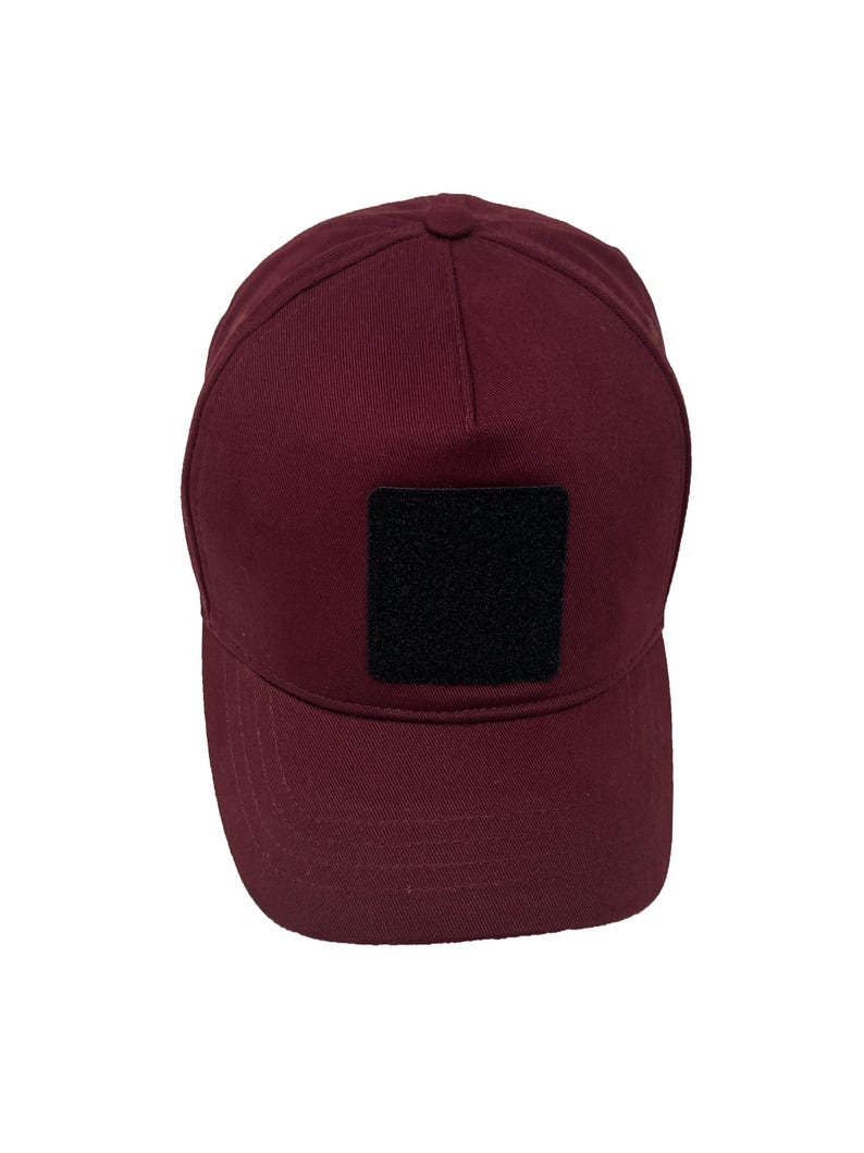 Burgundy cotton 5 panel hat with removable patch panel, adjustable closure and bold color.