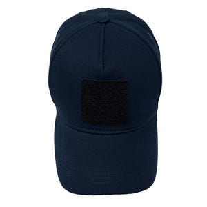Dark blue cotton 5 panel cap featuring a front Velcro patch panel, breathable and stylish.