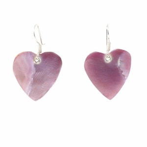 May include: A pair of heart-shaped earrings. Each earring features a polished, light purple heart pendant with a silver-colored hook. The earrings are displayed against a white background, highlighting their shape and color.