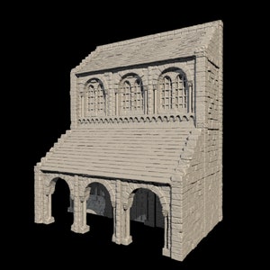 May include: A miniature, two-story stone building with a pitched roof. The structure features arched openings on the lower level and arched windows on the upper level. The building is constructed from light gray bricks and has a detailed, textured appearance.