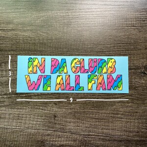 May include: A blue sticker with the text "IN DA CLUB WE ALL FAM" in colorful, wavy letters.