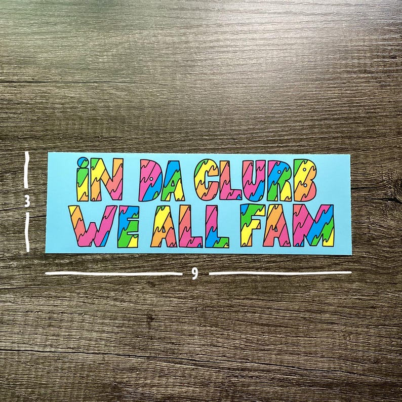 May include: A blue sticker with the text "IN DA CLUB WE ALL FAM" in colorful, wavy letters.