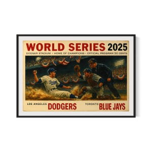 May include: A framed vintage baseball poster for the 2025 World Series, featuring the Los Angeles Dodgers versus the Toronto Blue Jays. The artwork depicts a baseball game scene with players in action, and the text "WORLD SERIES 2025" at the top.