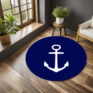 May include: A round navy blue rug with a white anchor design. The rug is on a wooden floor.