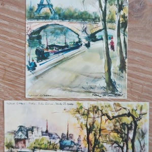 Conjunto de 2 postales sin usar de obras de Marius Girard; escenas emblemáticas de París: Ediciones "C'est Paris". Estado de conservación vintage