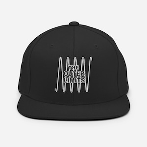 May include: A black baseball cap with a flat brim. The cap features the text "THE OUTER LIMITS" in white, with a stylized wavy design above and below the text. The cap is a classic, casual accessory.