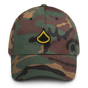 May include: Camouflage baseball cap with a black and gold embroidered insignia. The cap features a classic six-panel design with a curved brim and an adjustable strap. The fabric has a green, brown, and black camouflage pattern.
